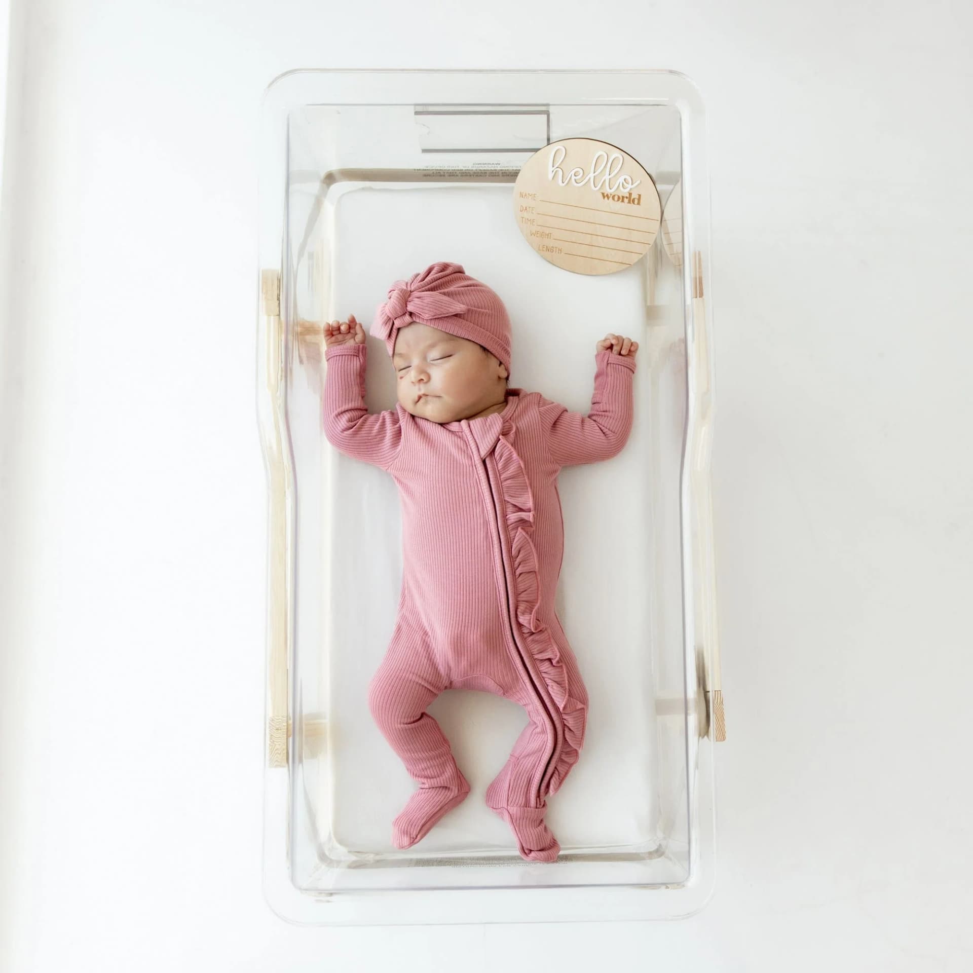 Ribbed Ruffle Zipper Footie in Apple Blossom by Kyte Baby